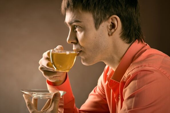 a man drinks herbal tea to treat prostatitis